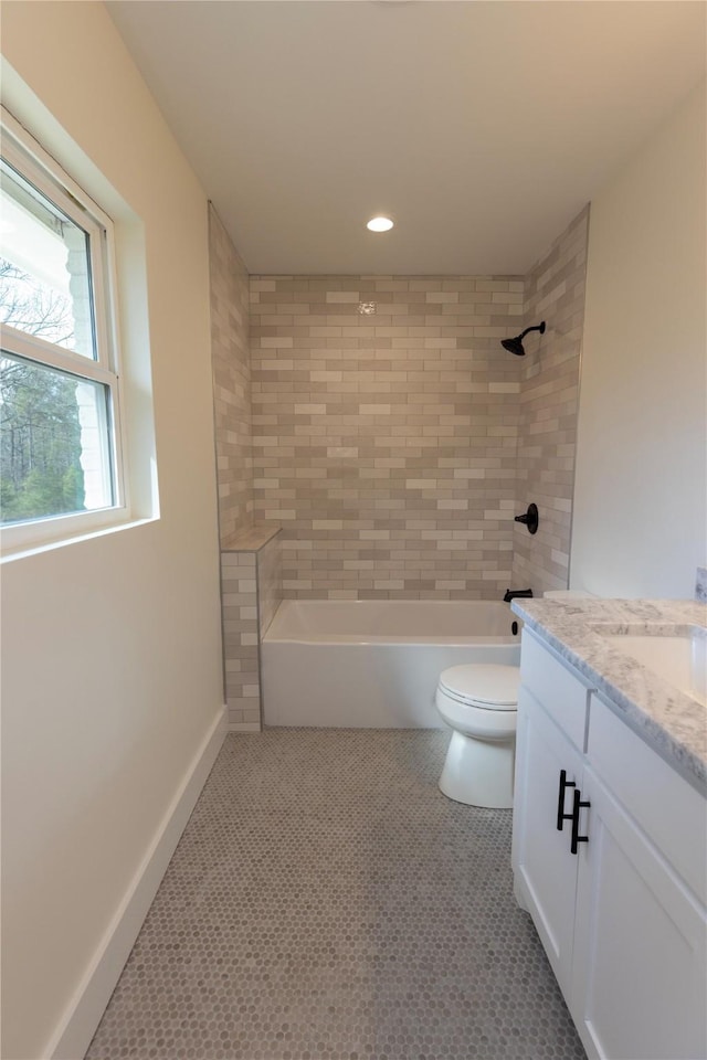 full bath featuring baseboards, toilet, tile patterned floors, vanity, and shower / washtub combination