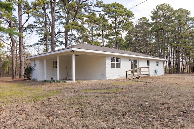 view of front facade featuring brick siding and an attached carport