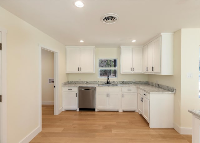 kitchen featuring visible vents, white cabinets, a sink, light wood-type flooring, and dishwasher