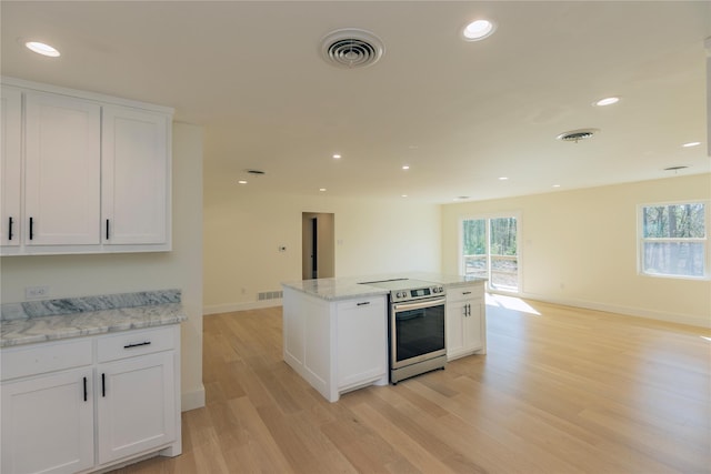 kitchen with visible vents, electric stove, light wood-type flooring, white cabinetry, and recessed lighting