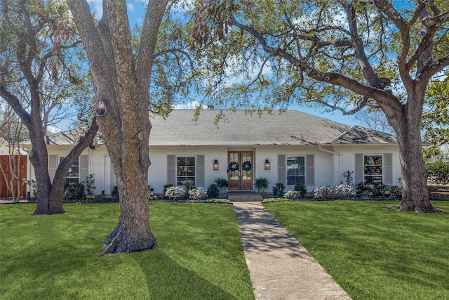 ranch-style home featuring french doors, a front lawn, and brick siding