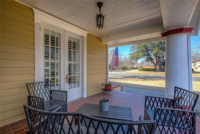 view of patio with french doors and a porch