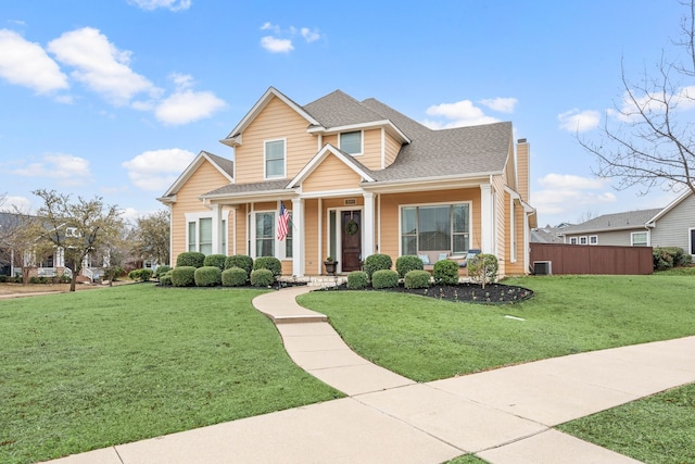 view of front of house with a shingled roof, a chimney, a front lawn, and central air condition unit