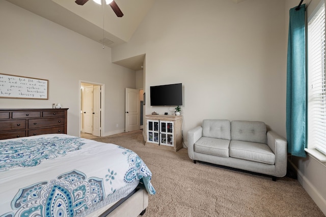 carpeted bedroom featuring baseboards, high vaulted ceiling, and a ceiling fan