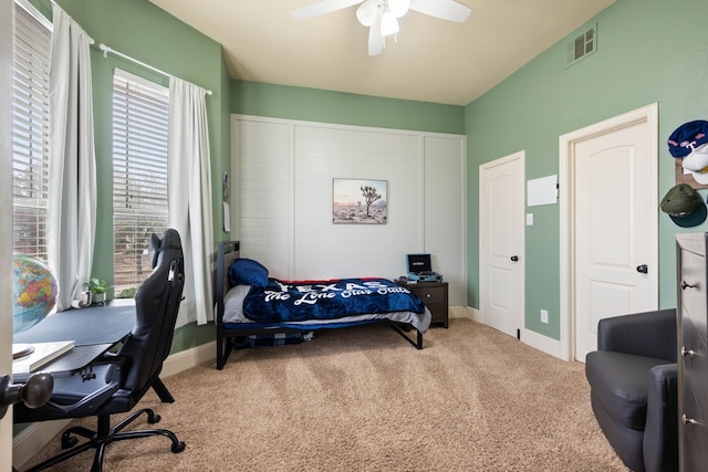 bedroom featuring baseboards, visible vents, ceiling fan, and carpet flooring