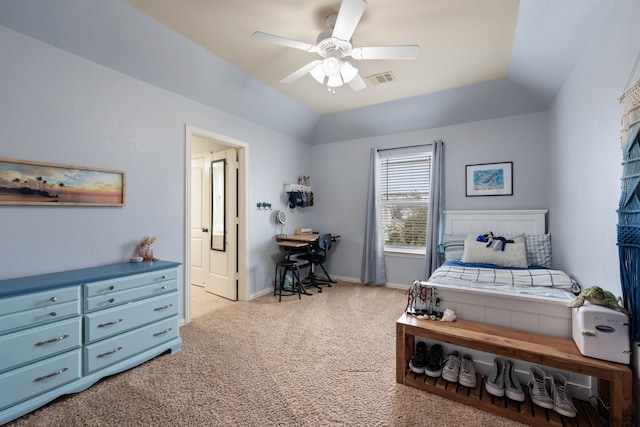 bedroom with baseboards, visible vents, light colored carpet, lofted ceiling, and ensuite bathroom