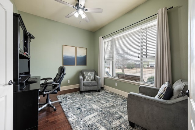 office space with dark wood-type flooring, a ceiling fan, and baseboards