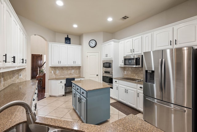 kitchen featuring appliances with stainless steel finishes, white cabinetry, and light tile patterned floors