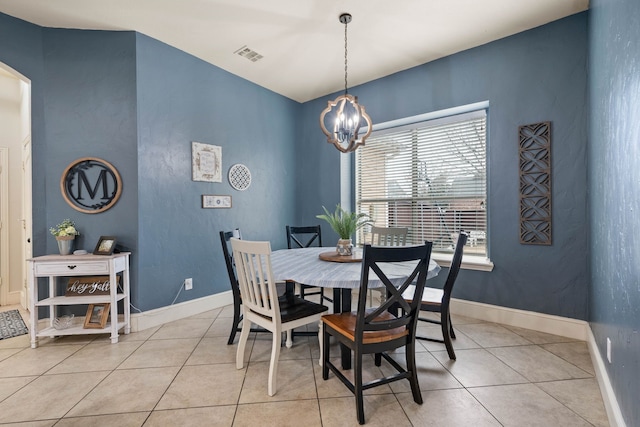 dining space featuring light tile patterned floors, baseboards, visible vents, arched walkways, and an inviting chandelier