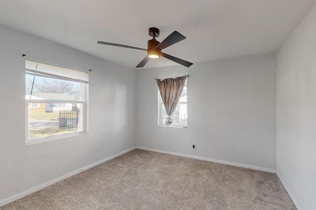 carpeted empty room with plenty of natural light, baseboards, and ceiling fan