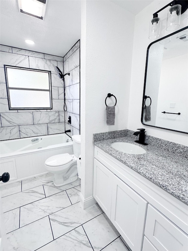 bathroom with bathtub / shower combination, toilet, vanity, visible vents, and marble finish floor