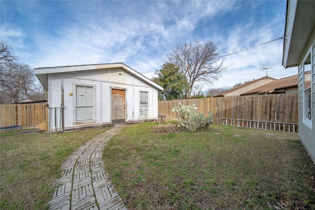 exterior space with a fenced backyard and an outdoor structure