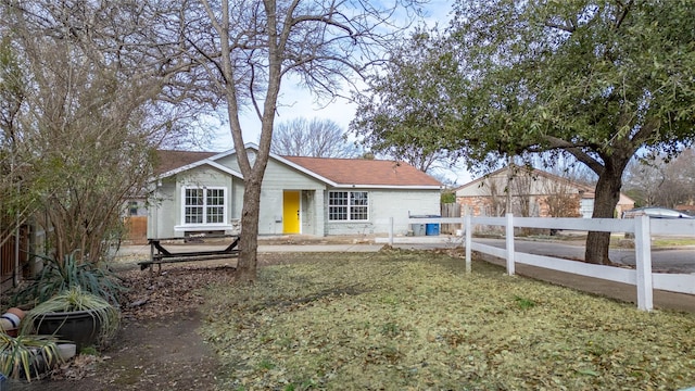 rear view of house featuring fence