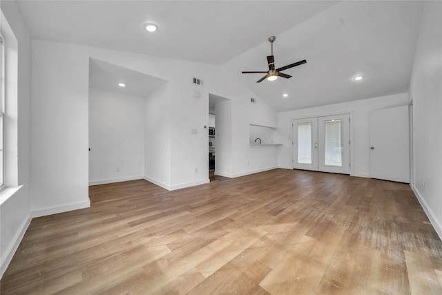 unfurnished living room with french doors, lofted ceiling, ceiling fan, light wood-type flooring, and baseboards