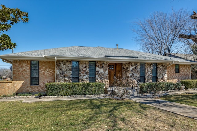 ranch-style home with stone siding, a front lawn, and brick siding