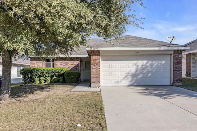 single story home with a garage, driveway, a front lawn, and brick siding