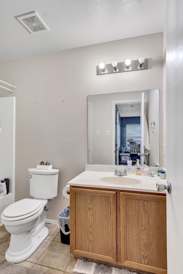 bathroom featuring visible vents, toilet, vanity, a textured ceiling, and tile patterned flooring