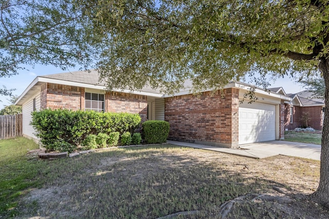 single story home with concrete driveway, brick siding, fence, and an attached garage