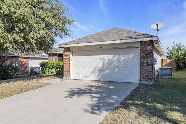 exterior space featuring concrete driveway, an attached garage, fence, an outdoor structure, and brick siding