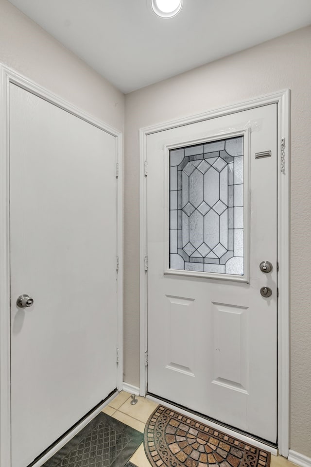 entryway with light tile patterned floors