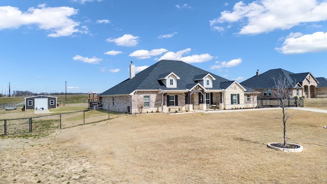 view of front facade with brick siding and fence