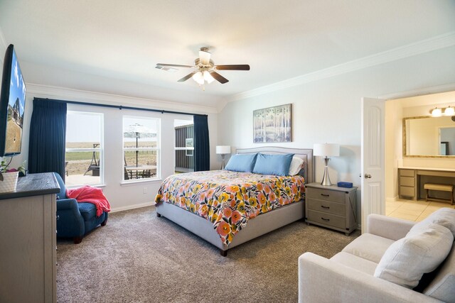 bedroom featuring visible vents, baseboards, carpet floors, ornamental molding, and ensuite bathroom