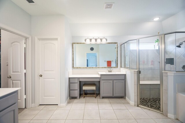 bathroom featuring tile patterned flooring, visible vents, a shower stall, and vanity