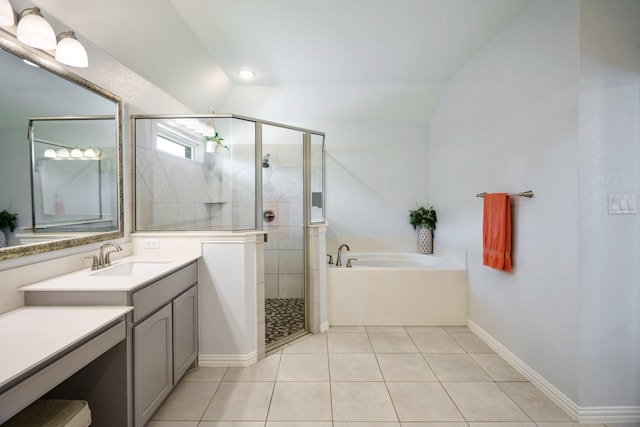 bathroom with a garden tub, a stall shower, tile patterned flooring, vanity, and vaulted ceiling