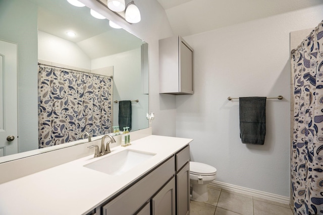 full bath featuring baseboards, toilet, vaulted ceiling, tile patterned floors, and vanity