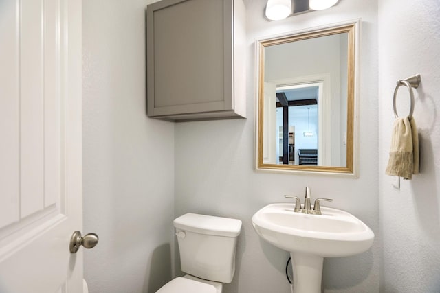 bathroom featuring toilet and a sink