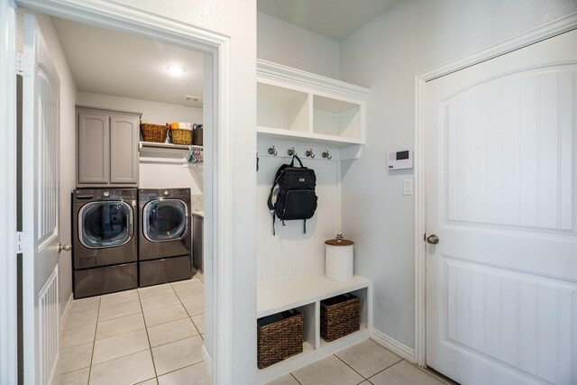 mudroom featuring light tile patterned floors and washing machine and dryer