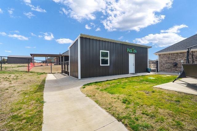 view of outbuilding with fence