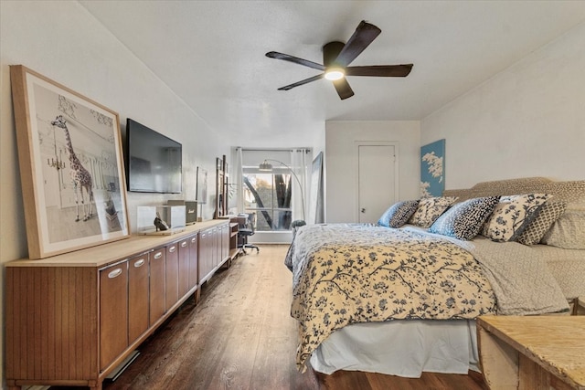 bedroom with ceiling fan and dark wood-style flooring