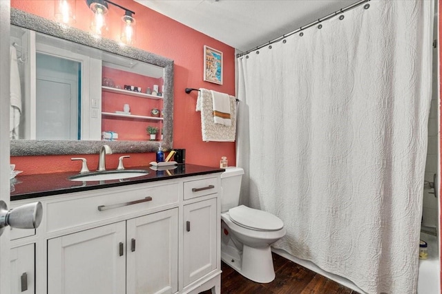 bathroom with vanity, wood finished floors, toilet, and a shower with curtain