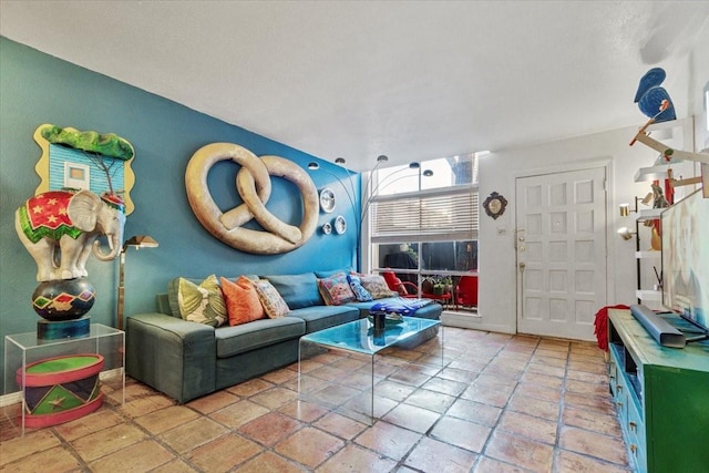 living area featuring baseboards