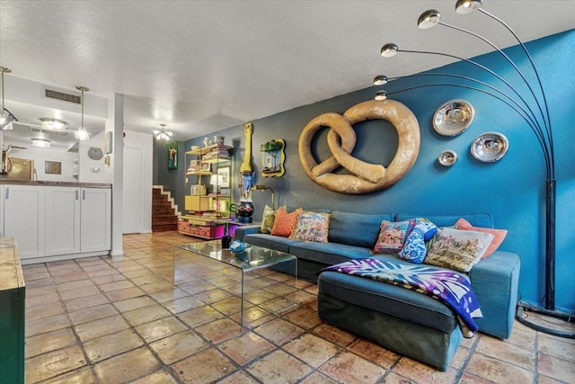 living area featuring stairway and visible vents