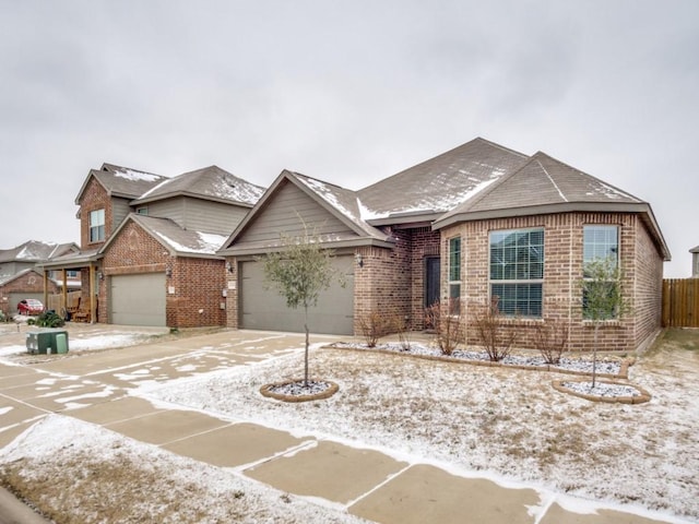 ranch-style house with a garage, fence, and brick siding