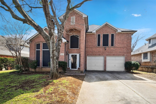 traditional home featuring concrete driveway, brick siding, and an attached garage