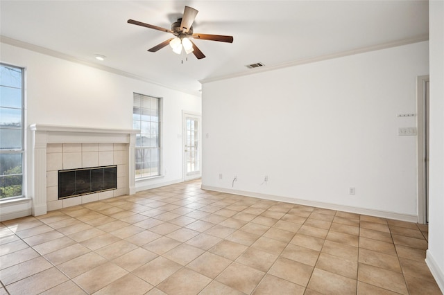 unfurnished living room featuring baseboards, a fireplace, visible vents, and crown molding