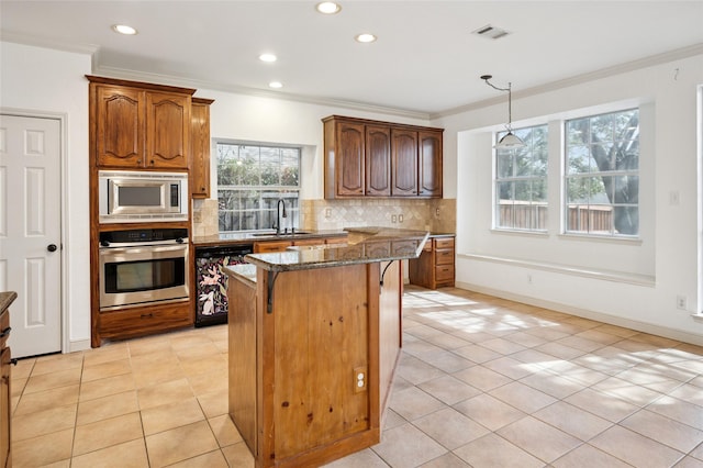 kitchen with visible vents, dark stone counters, a sink, stainless steel appliances, and backsplash