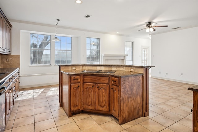 kitchen with light tile patterned floors, black electric stovetop, visible vents, ornamental molding, and tasteful backsplash