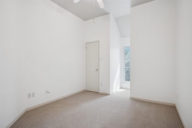 unfurnished room featuring baseboards, high vaulted ceiling, ceiling fan, and light colored carpet