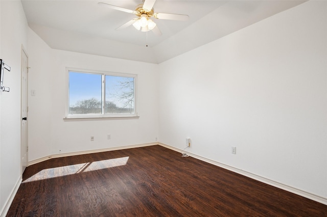 spare room featuring dark wood-type flooring, baseboards, and a ceiling fan