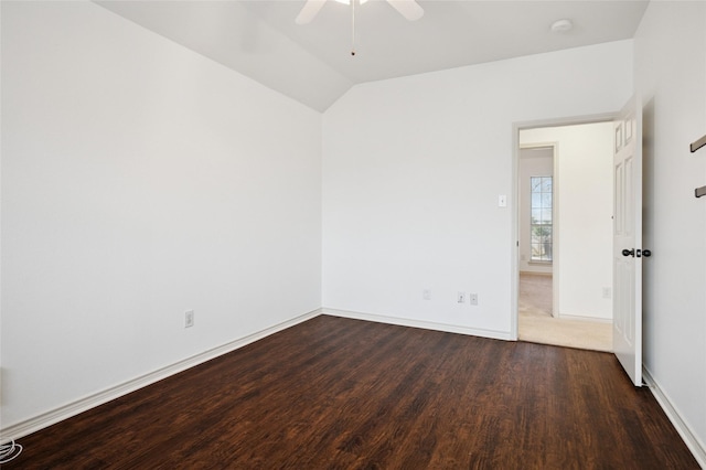 spare room featuring vaulted ceiling, ceiling fan, wood finished floors, and baseboards