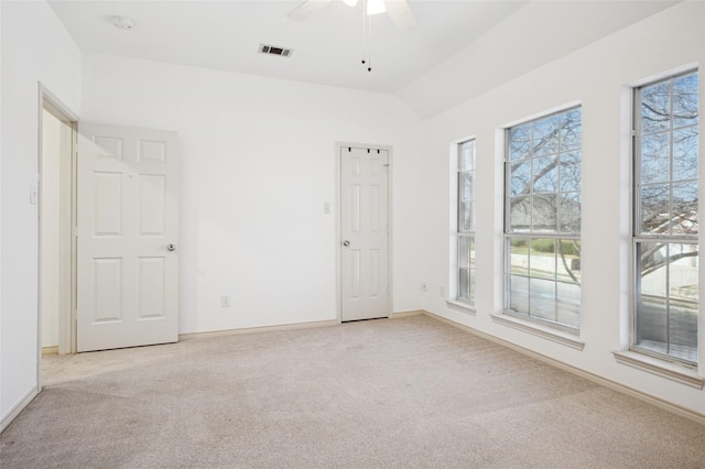 interior space featuring a healthy amount of sunlight, light carpet, and visible vents