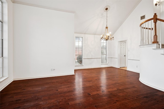 unfurnished dining area with a chandelier, hardwood / wood-style floors, and stairway