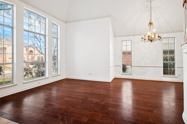 unfurnished dining area with lofted ceiling, a wealth of natural light, crown molding, and hardwood / wood-style floors