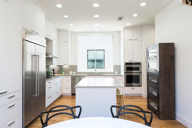 dining space featuring recessed lighting, visible vents, stairs, and light wood finished floors