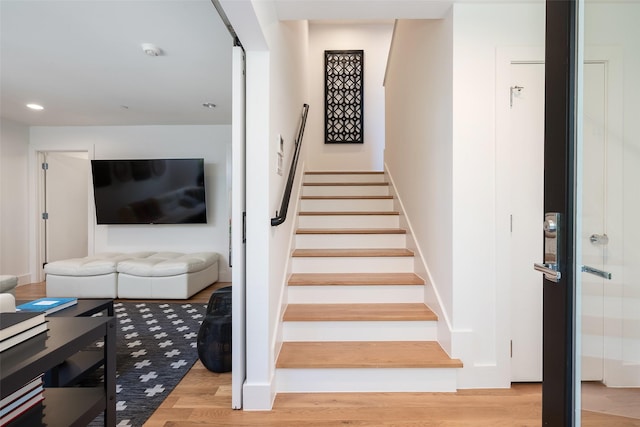 stairs featuring recessed lighting, baseboards, and wood finished floors