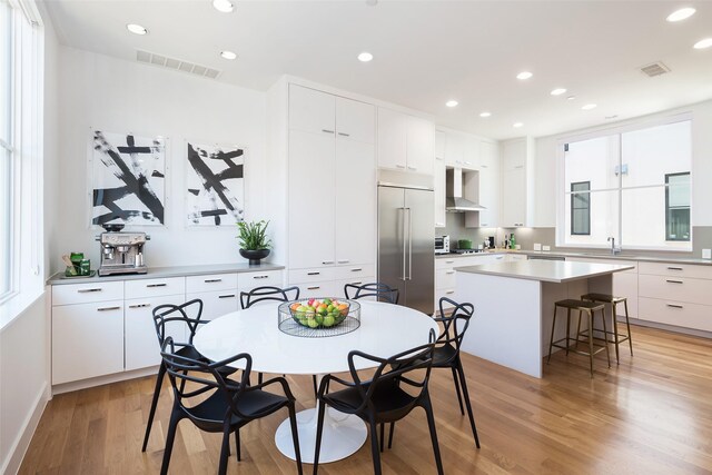 dining area featuring recessed lighting, visible vents, light wood-style floors, and a wealth of natural light